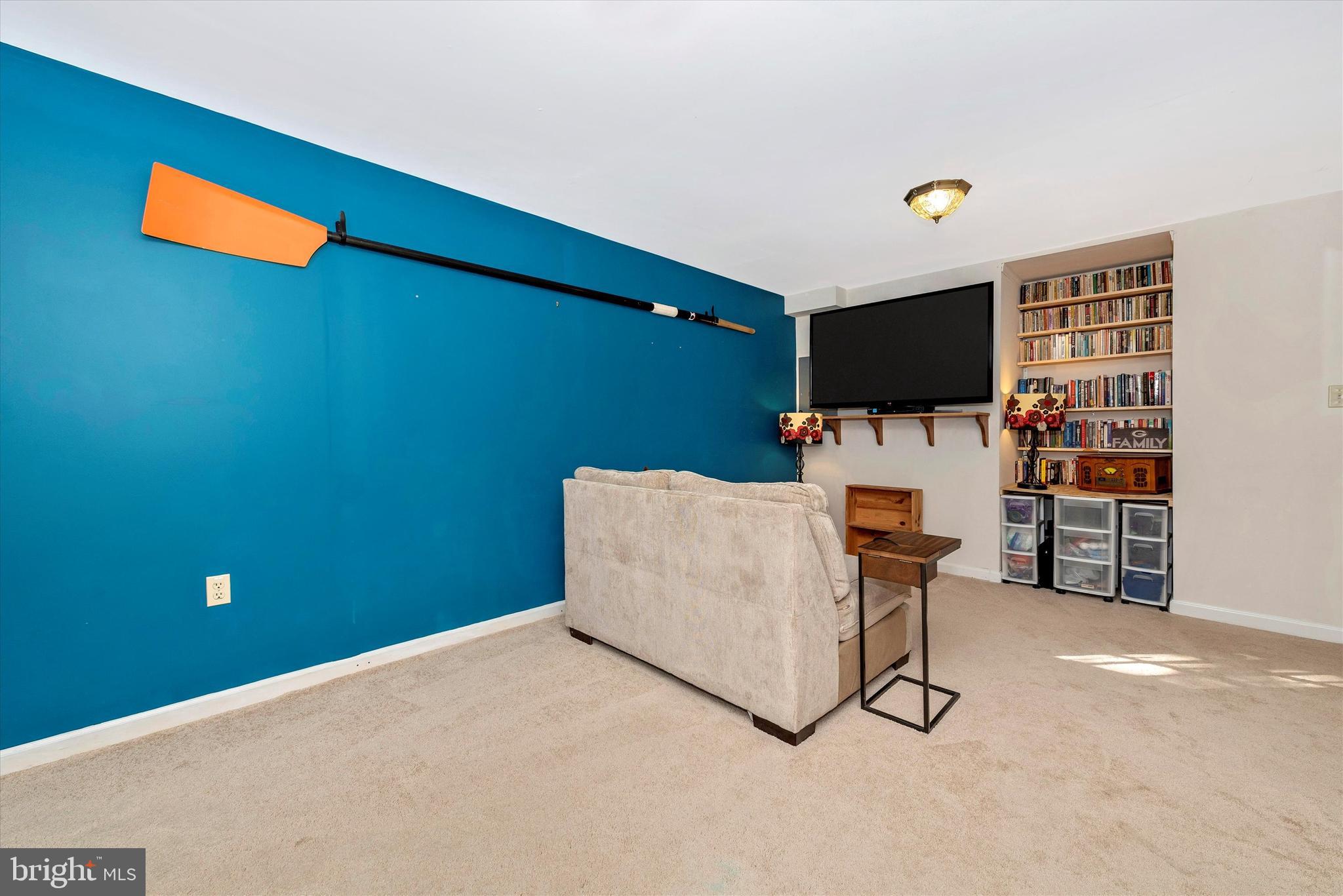 6715 Hemlock Point Road New Market, MD 21774 - Photo 22 of 51 Finished basement with more built-in shelving.