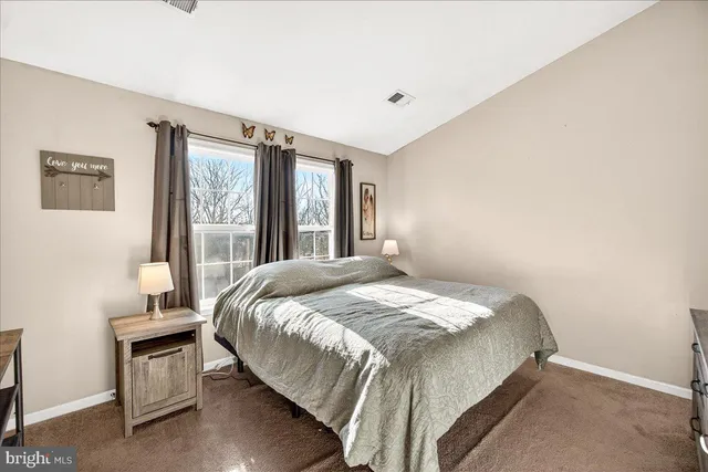 a bed sitting in a bedroom next to a window