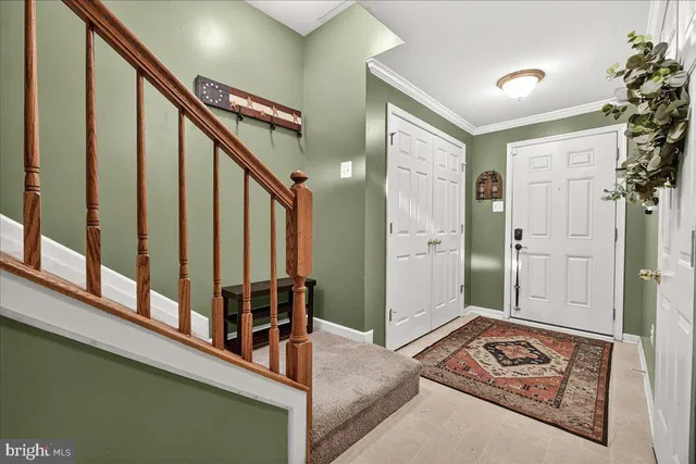 a view of a hallway with entryway and furniture