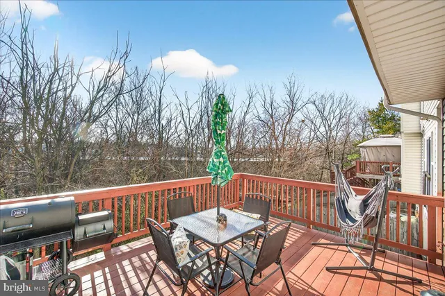 a view of a patio with table and chairs
