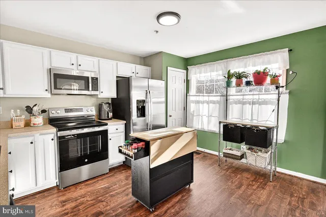 a kitchen with stainless steel appliances granite countertop a stove and a refrigerator