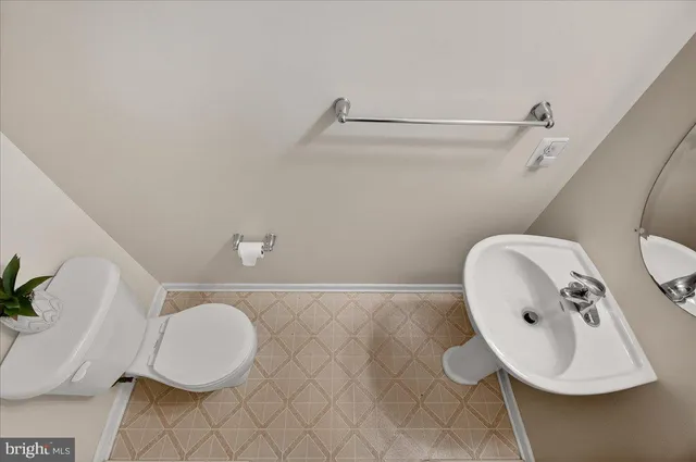 a bathroom with a toilet and a mirror