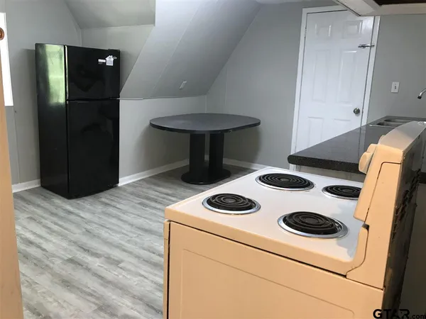 a kitchen with a stove and a refrigerator