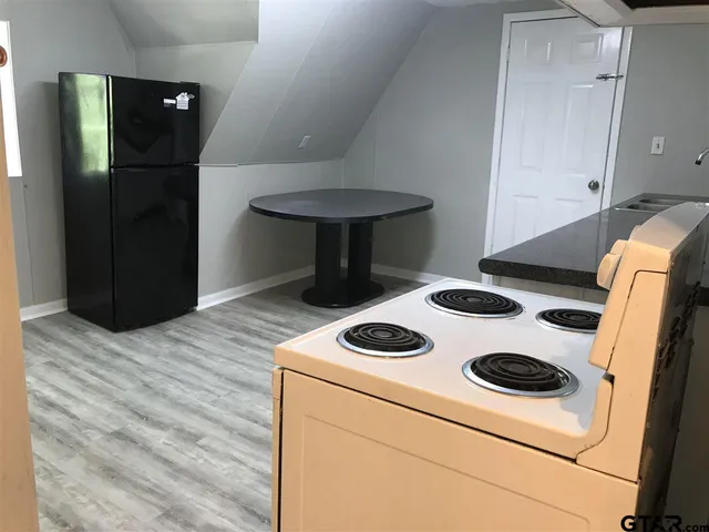 a kitchen with a stove and a refrigerator