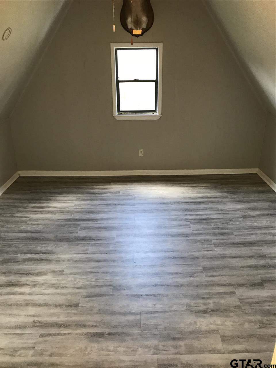 208 West Phillips Street, Unit 300 Tyler, TX 75701 - Photo 10 of 12 a view of a room with wooden floor and window