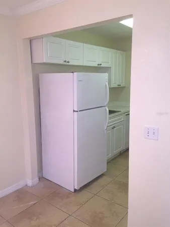 a view of a kitchen with a refrigerator and a microwave