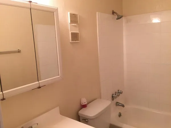 a bathroom with a toilet and shower