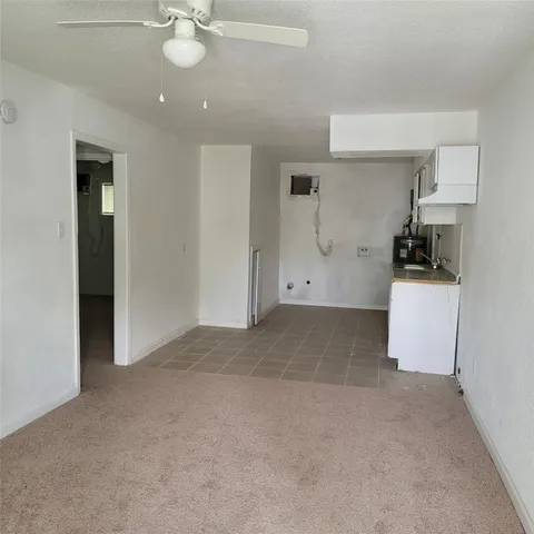 a view of a kitchen with a sink and a refrigerator