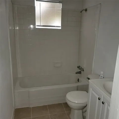 a bathroom with a toilet and a bathtub
