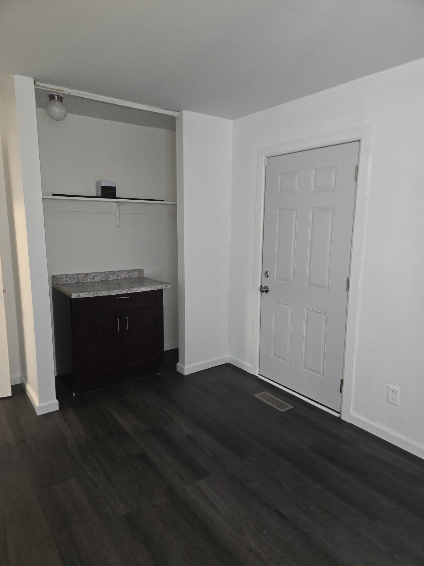 1932 Arthur Street Gary, IN 46404 - Photo 6 of 14 an empty room with wooden floor fireplace and windows