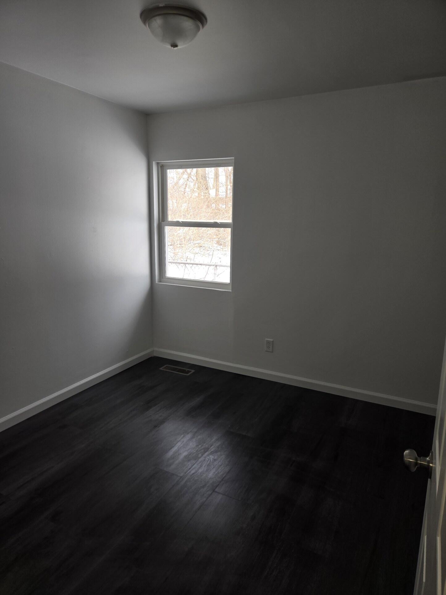 1932 Arthur Street Gary, IN 46404 - Photo 7 of 14 an empty room with wooden floor and windows