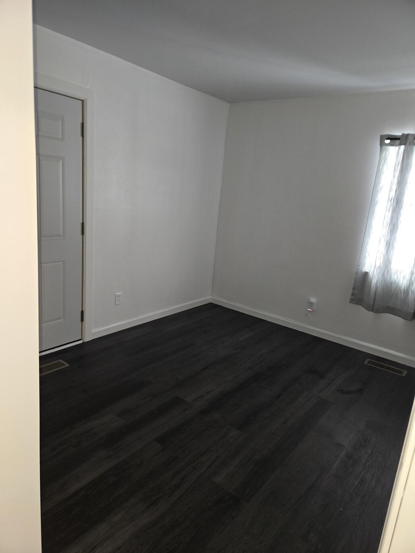 1932 Arthur Street Gary, IN 46404 - Photo 8 of 14 an empty room with wooden floor and windows