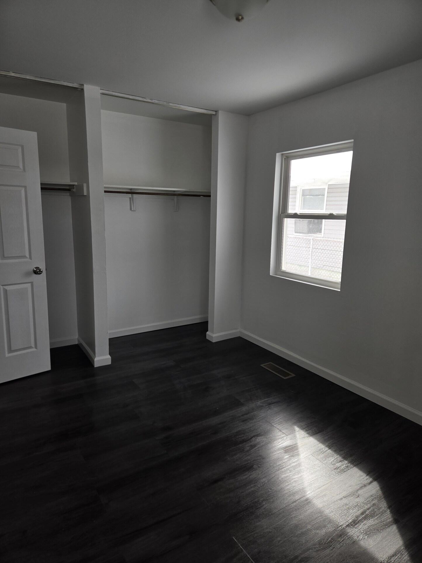 1932 Arthur Street Gary, IN 46404 - Photo 10 of 14 a view of an empty room with wooden floor and a window
