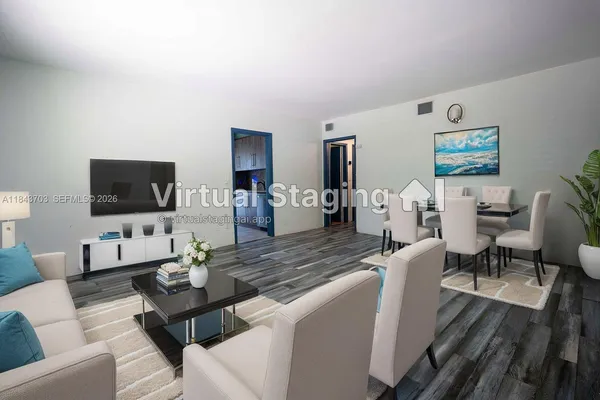 a living room with furniture flat screen tv and wooden floor