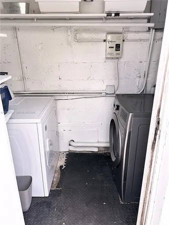 a view of storage and utility room with a washer dryer