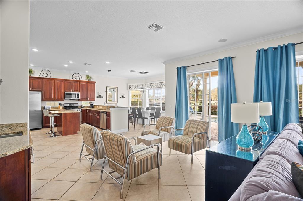 7388 Gathering Court Reunion, FL 34747 - Photo 15 of 56 a living room with lots of furniture and kitchen view