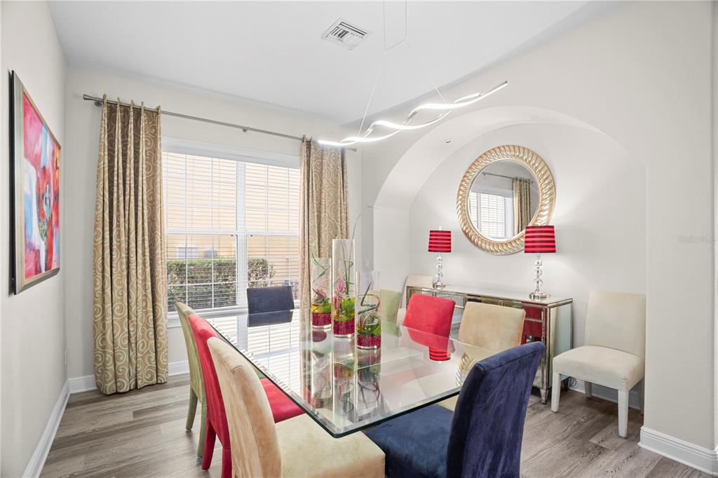 7388 Gathering Court Reunion, FL 34747 - Photo 18 of 56 a view of a dining room with furniture window and wooden floor