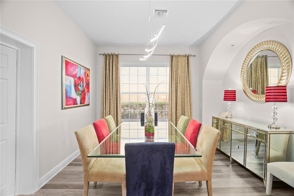 7388 Gathering Court Reunion, FL 34747 - Photo 19 of 56 a view of a dining room with furniture window and wooden floor