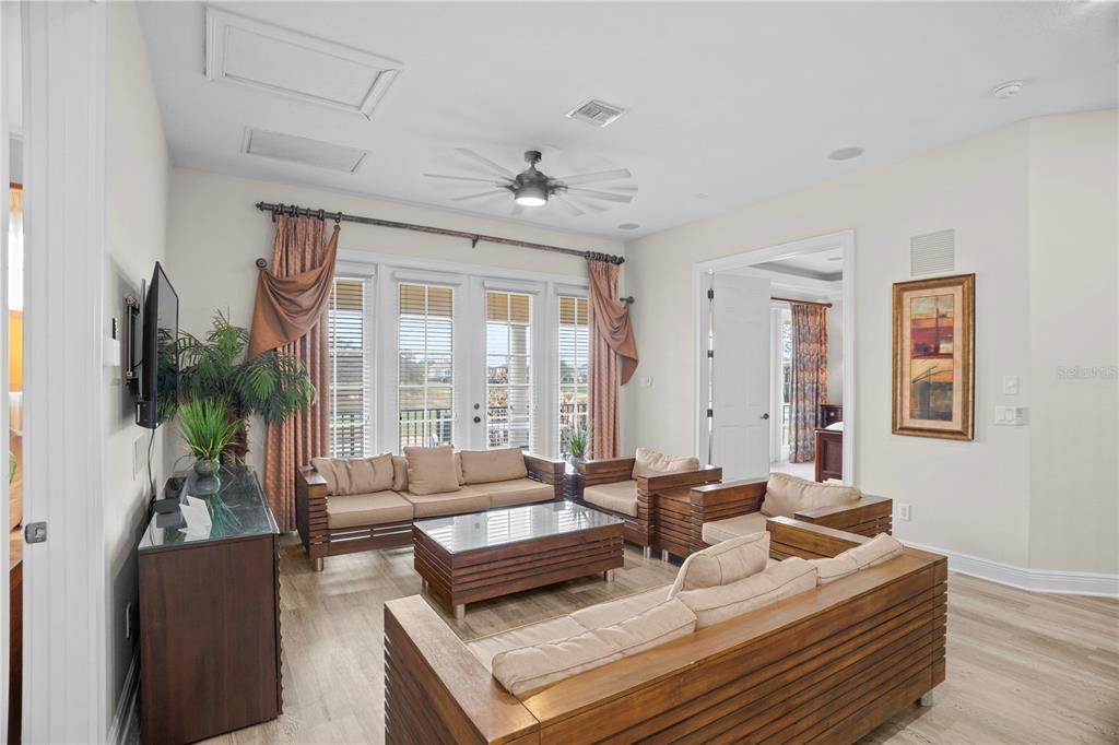 7388 Gathering Court Reunion, FL 34747 - Photo 23 of 56 a living room with furniture and a large window
