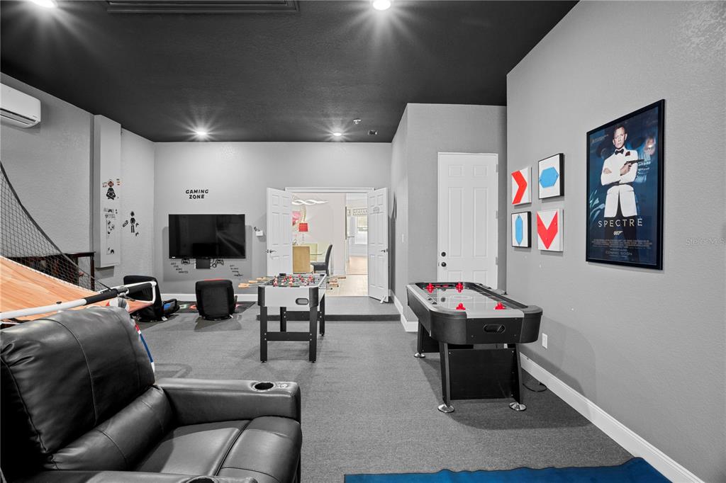 7388 Gathering Court Reunion, FL 34747 - Photo 26 of 56 a living room with furniture and a flat screen tv