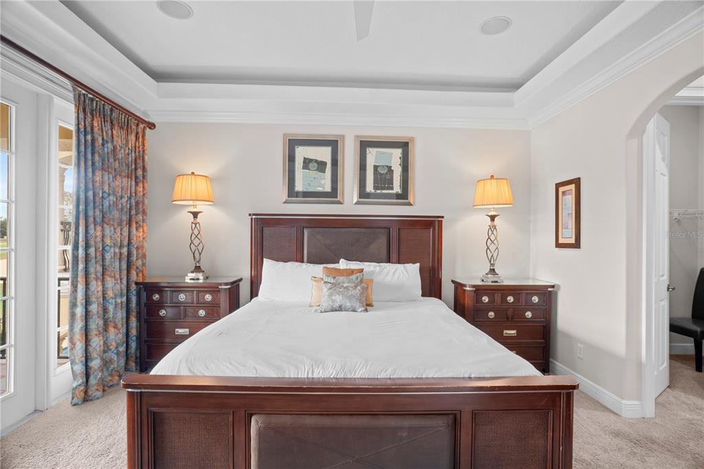 7388 Gathering Court Reunion, FL 34747 - Photo 27 of 56 a bedroom with a large bed and a dresser