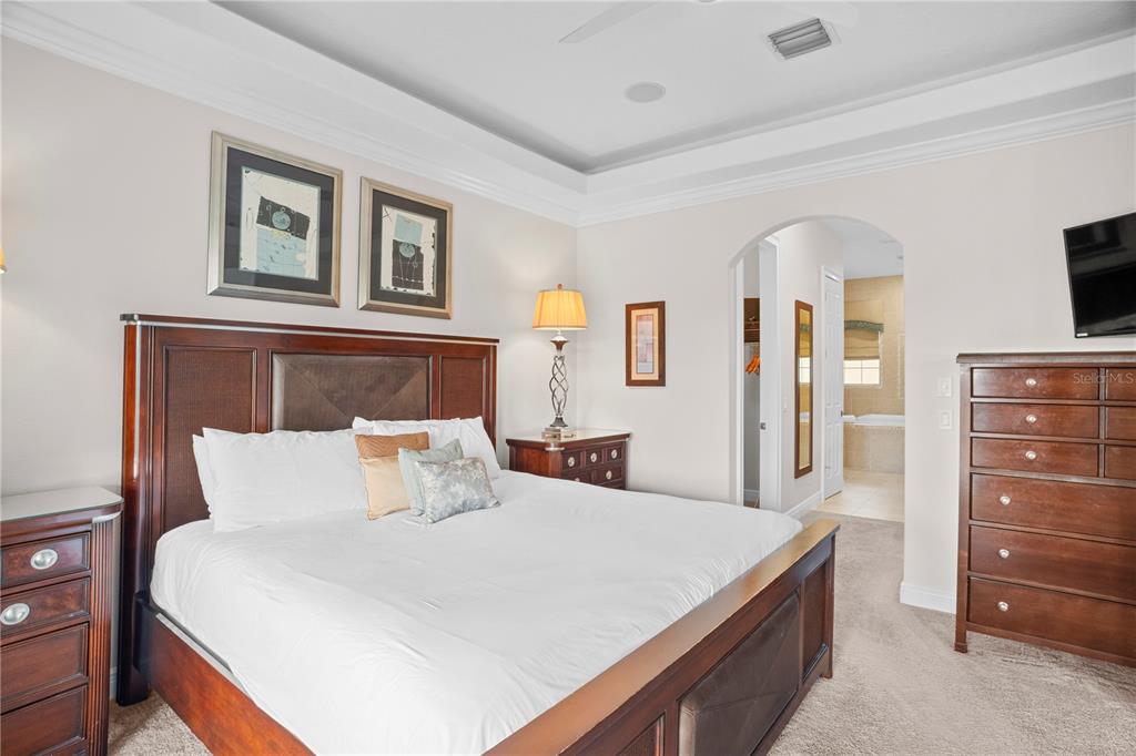 7388 Gathering Court Reunion, FL 34747 - Photo 28 of 56 a bedroom with a bed and a dresser