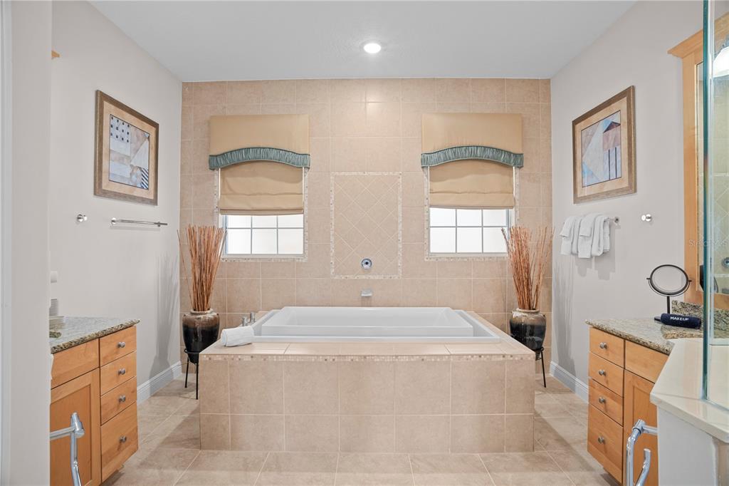 7388 Gathering Court Reunion, FL 34747 - Photo 30 of 56 a spacious bedroom with a bed and a cabinets