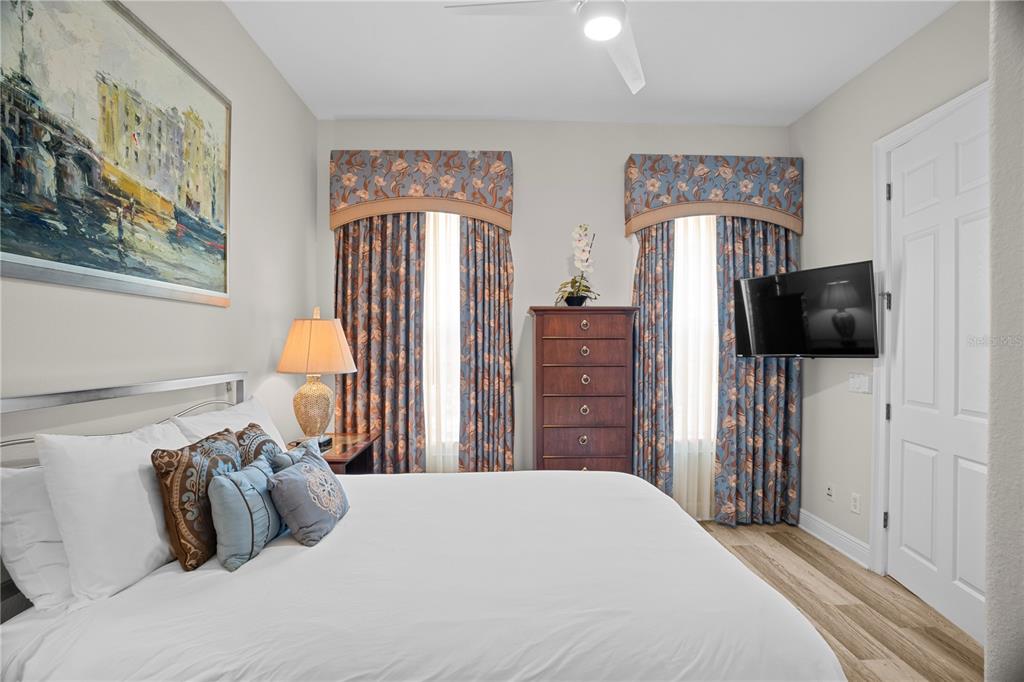 7388 Gathering Court Reunion, FL 34747 - Photo 34 of 56 a bedroom with a bed and a flat screen tv