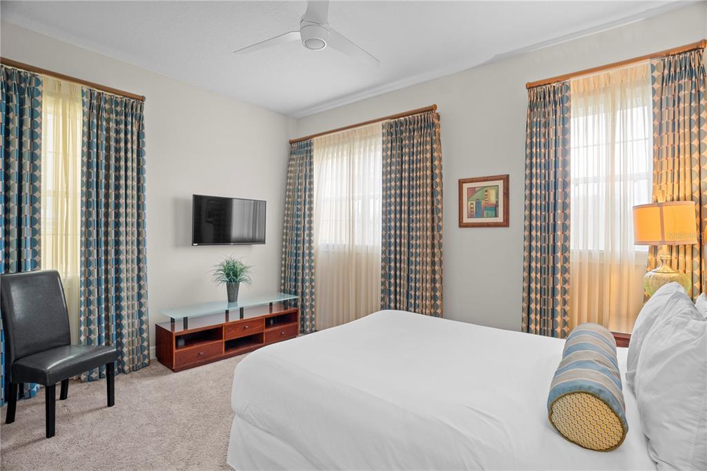 7388 Gathering Court Reunion, FL 34747 - Photo 38 of 56 a bedroom with a bed and a flat screen tv