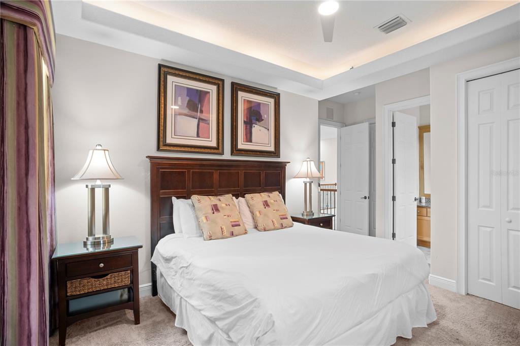 7388 Gathering Court Reunion, FL 34747 - Photo 41 of 56 a bedroom with a bed and a lamp on table