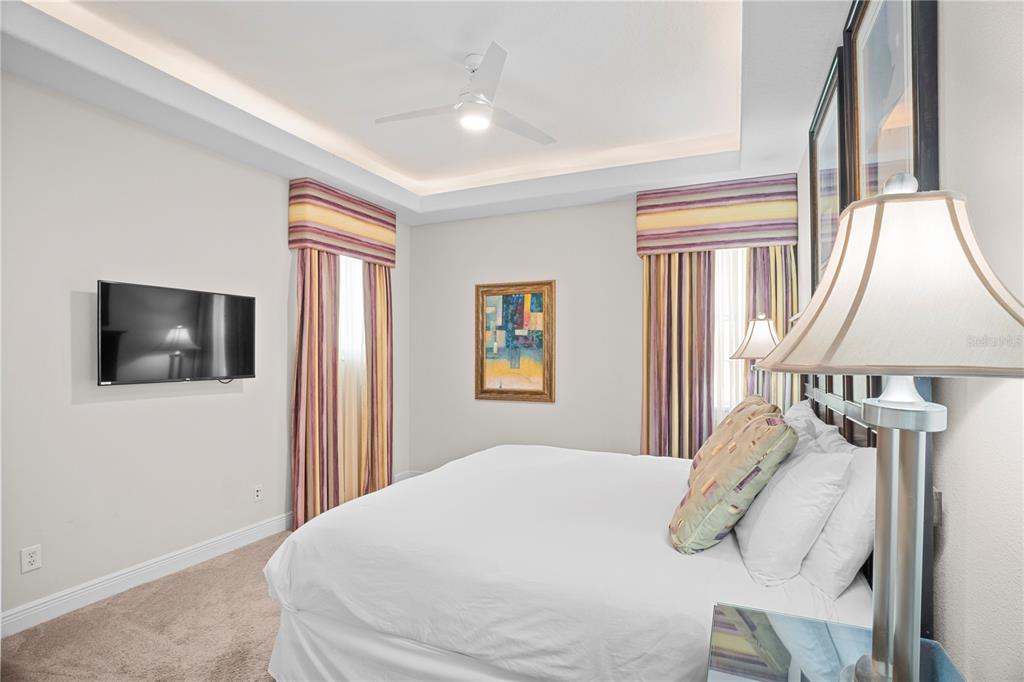 7388 Gathering Court Reunion, FL 34747 - Photo 42 of 56 a bedroom with a bed and a flat screen tv