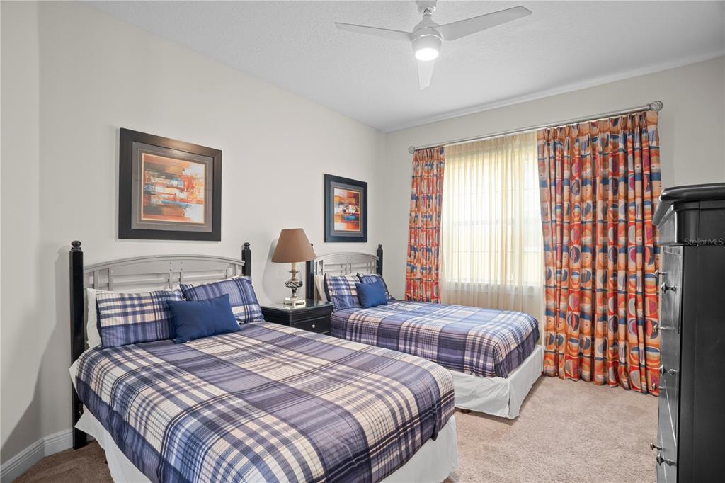7388 Gathering Court Reunion, FL 34747 - Photo 44 of 56 a bedroom with two beds and a large window