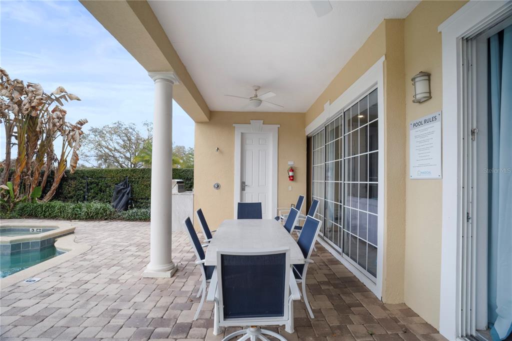 7388 Gathering Court Reunion, FL 34747 - Photo 51 of 56 a view of a patio with table and chairs and potted plants