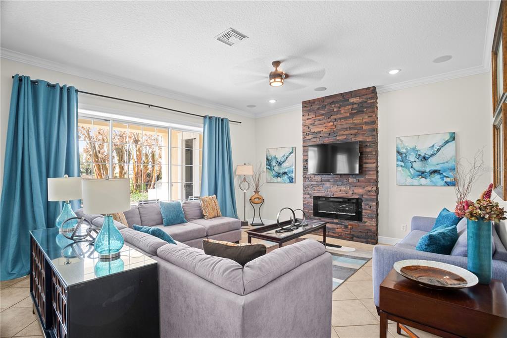 7388 Gathering Court Reunion, FL 34747 - Photo 7 of 56 a living room with furniture fireplace and a large window