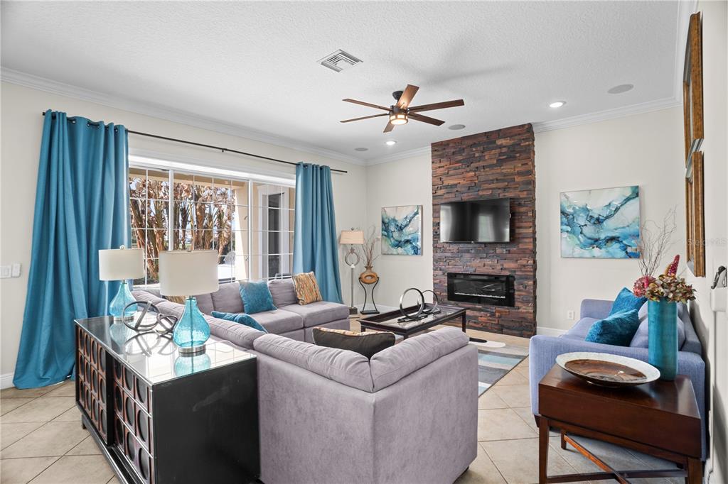 7388 Gathering Court Reunion, FL 34747 - Photo 10 of 56 a living room with furniture and a fireplace