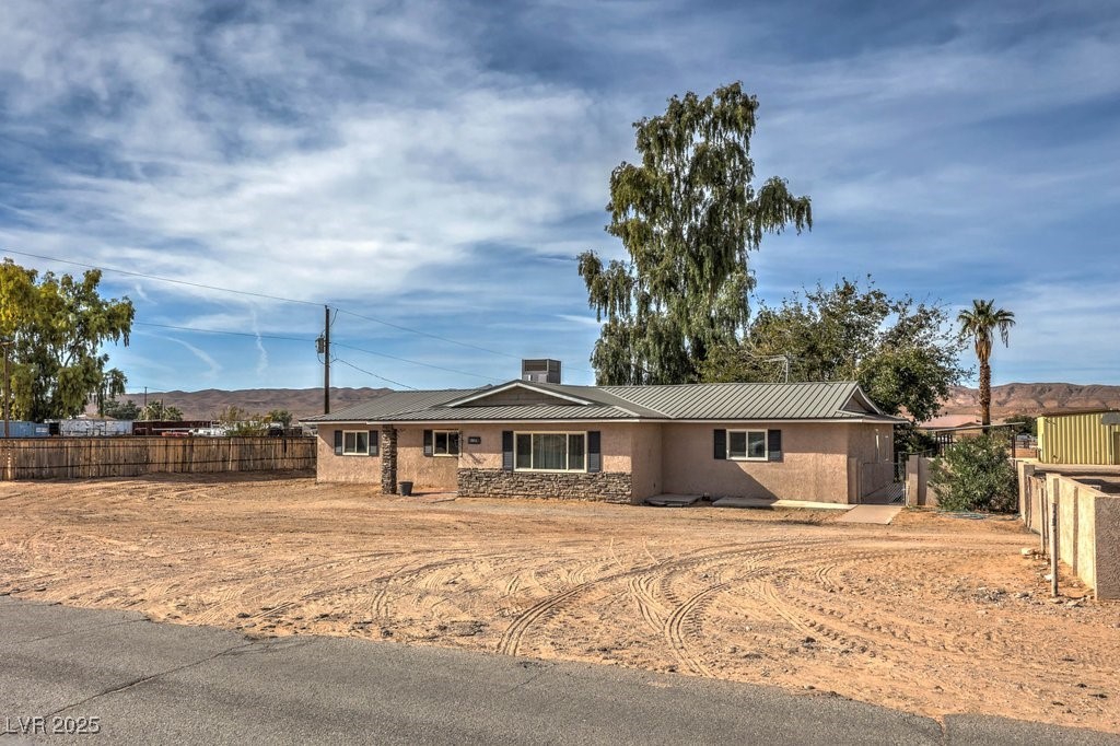 3811 Skyline Street Logandale, NV 89021 - Photo 2 of 58 Single story home featuring stucco siding, a metal roof, and stone siding