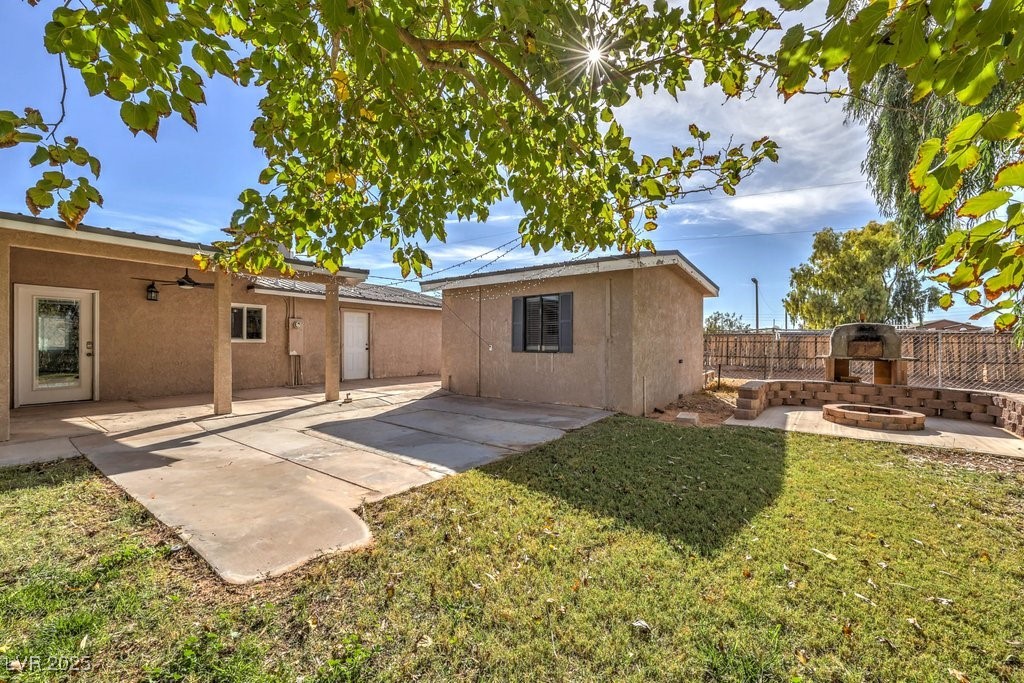 3811 Skyline Street Logandale, NV 89021 - Photo 36 of 58 Rear view of house featuring a patio, guest quarters, fire pit, and pizza oven