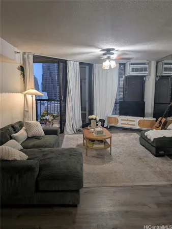 a living room with furniture and a chandelier