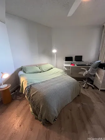 a bedroom with a bed and gym equipment