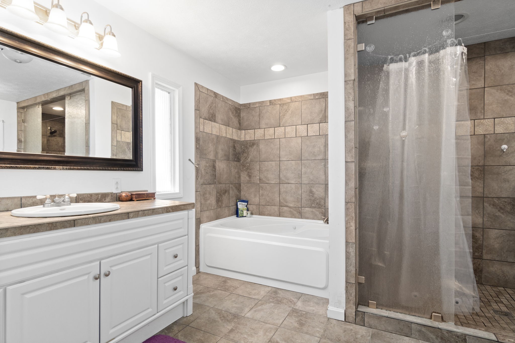 5150 Cadiz Road Hopkinsville, KY 42240 - Photo 25 of 45 a bathroom with a tub a sink and a mirror