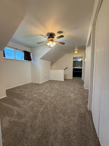 a view of a livingroom with a ceiling fan and window