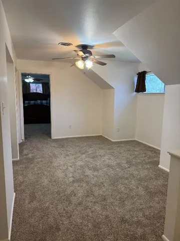 an empty room with closet and windows