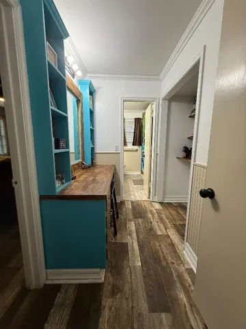 a living room with a bed and a dresser