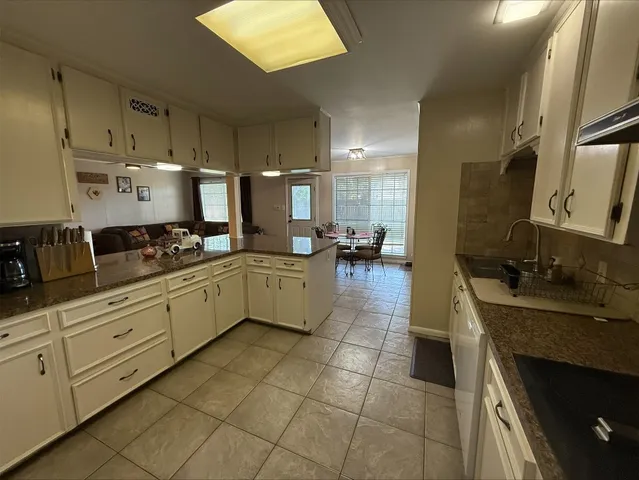 a kitchen with stainless steel appliances a sink stove and cabinets