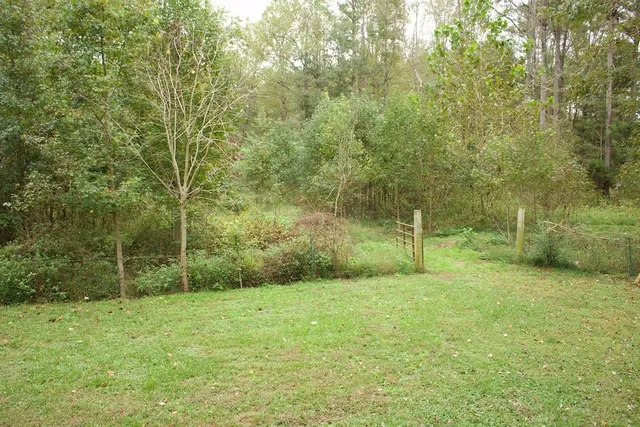 a bed room with a bed and a chair