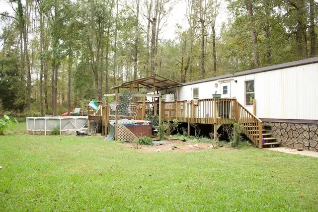 a view of balcony with wooden floor and seating