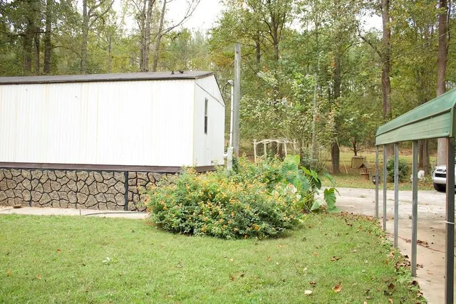 a view of a big yard with large trees