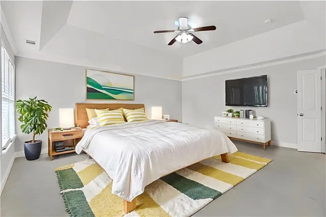 a bedroom with a bed furniture and a flat screen tv