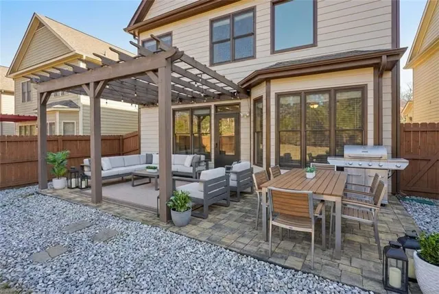 a view of a patio with table and chairs and potted plants