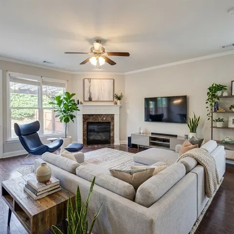 a living room with furniture a flat screen tv and a fireplace